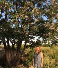 photo of Judy with lilac tree
